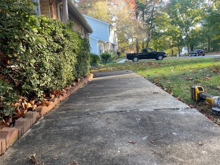 Sunken concrete walkway with cracks before leveling