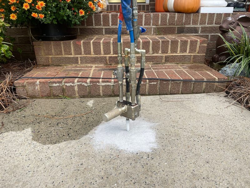 Polyurethane foam injection leveling sunken concrete beside steps in Chicago